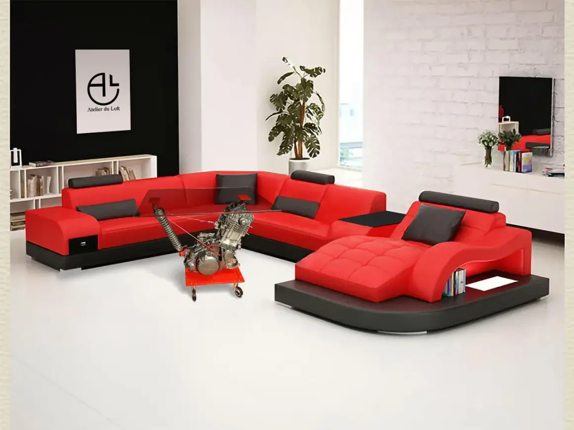 Salon moderne avec canapé rouge et noir, table basse originale intégrant un moteur de moto. Une déco table moto unique pour les passionnés.