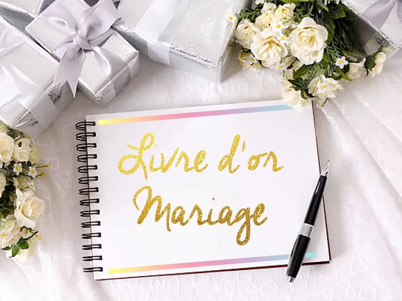 Un livre d'or à customiser pour un mariage, entouré de cadeaux et de fleurs.