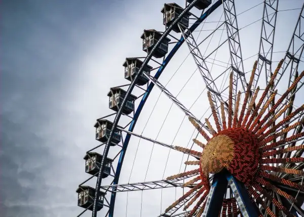 Grande roue de fête foraine, idéale pour une deco fete foraine a imprimer. Ses nacelles et son centre lumineux rappellent la magie des fêtes.